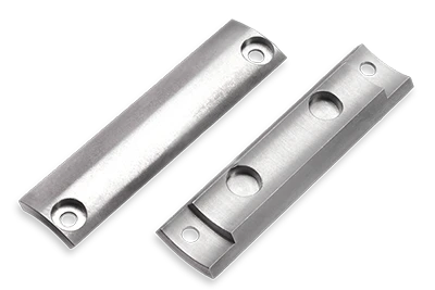 Two silver metal plates with holes, placed side by side on a white surface. One plate has two round indentations, while the other has a smooth surface. Both have holes near each end for mounting.