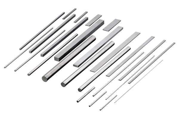 A group of metallic rods and rectangular bars of varying lengths and thicknesses are arranged in parallel on a white background, casting distinct black shadows.