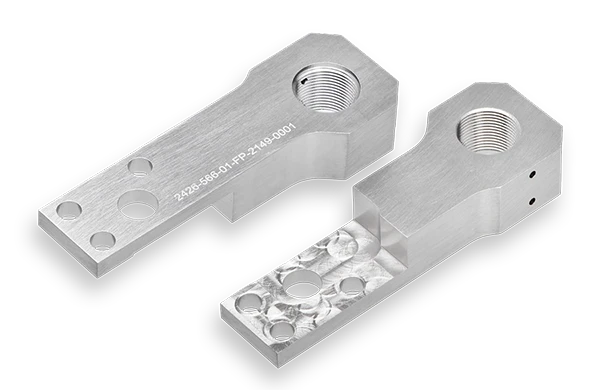 Two machined aluminum parts with threaded holes, smooth surfaces, engraved serial numbers, and multiple circular cutouts, placed on a plain black background.